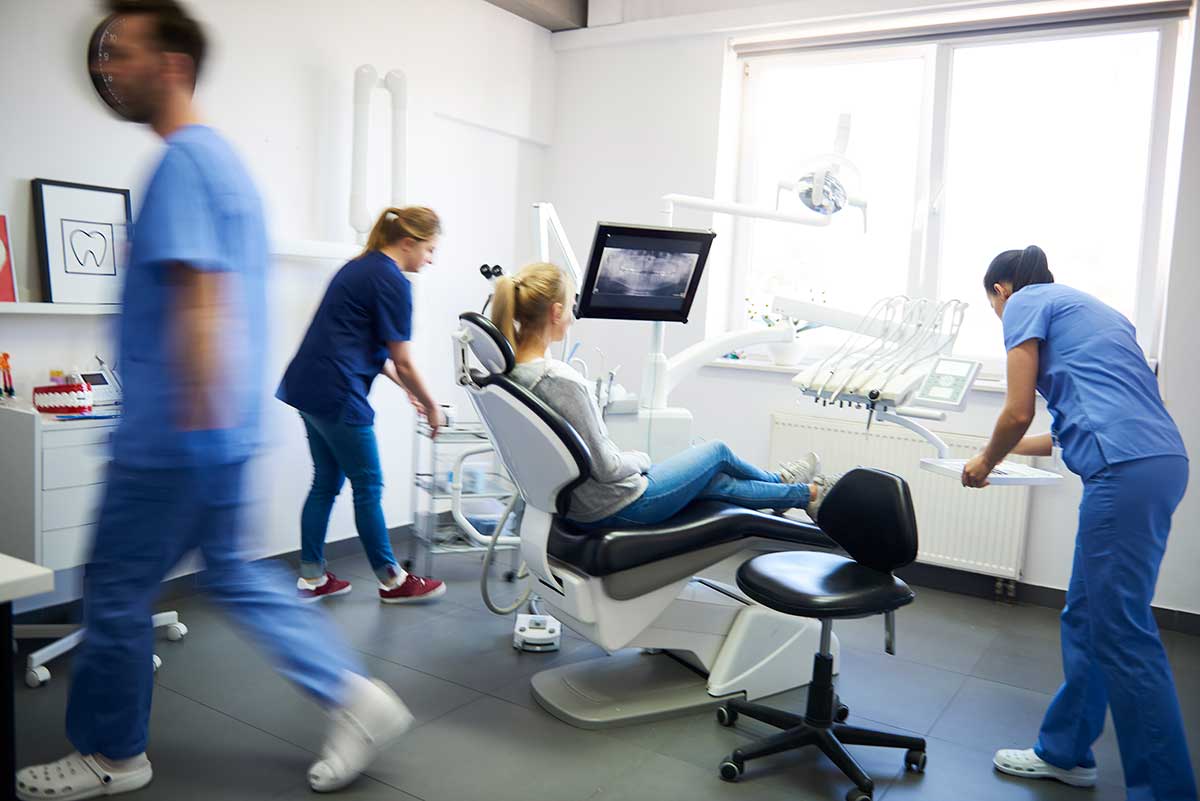 Dentists and woman in emergency dental